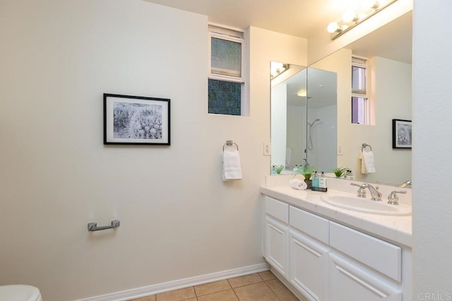 bathroom featuring tile patterned floors, vanity, and walk in shower