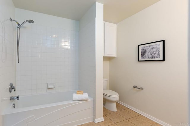 bathroom featuring tile patterned floors, tiled shower / bath, and toilet