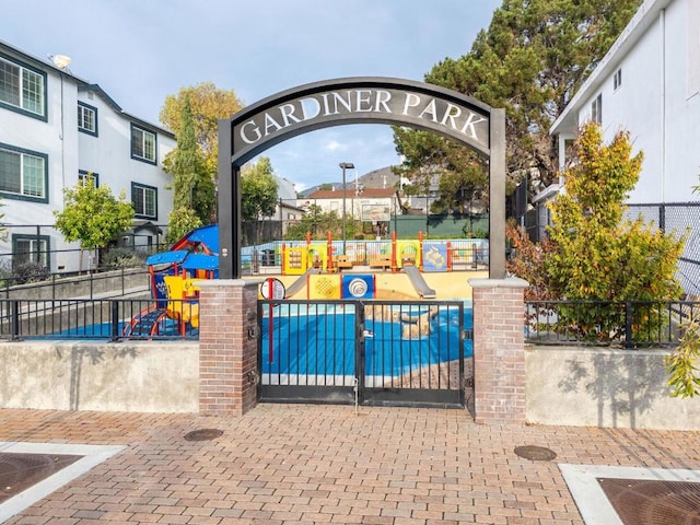 surrounding community featuring a playground and a swimming pool