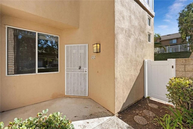 property entrance featuring a patio