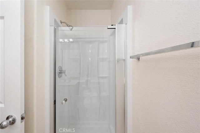 bathroom with a shower with shower door