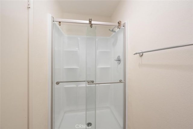 bathroom featuring a shower with door