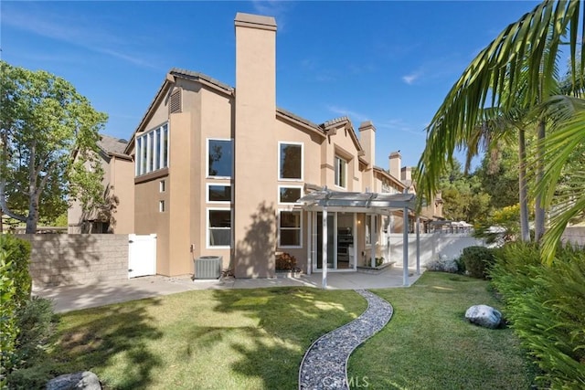 rear view of property with a pergola, central AC, a patio area, and a yard