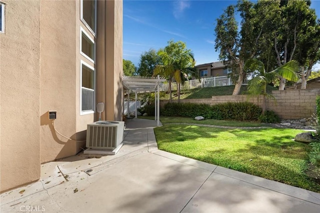 view of yard with a pergola, a patio, and central AC unit