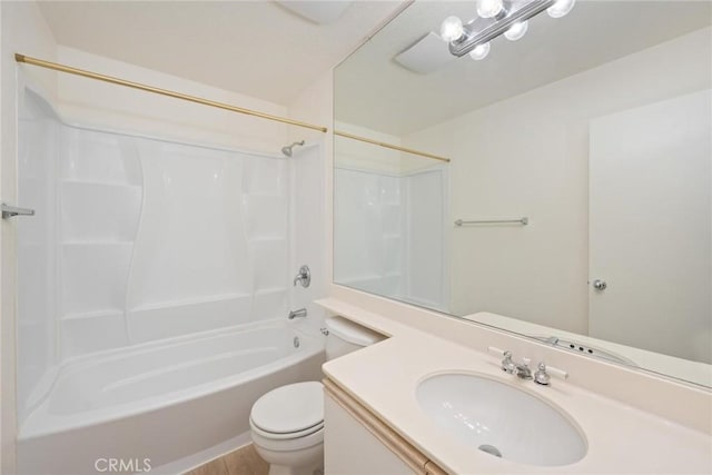 full bathroom featuring toilet, vanity, and washtub / shower combination