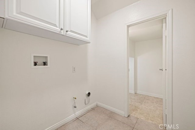 laundry room featuring gas dryer hookup, hookup for a washing machine, light tile patterned floors, and cabinets