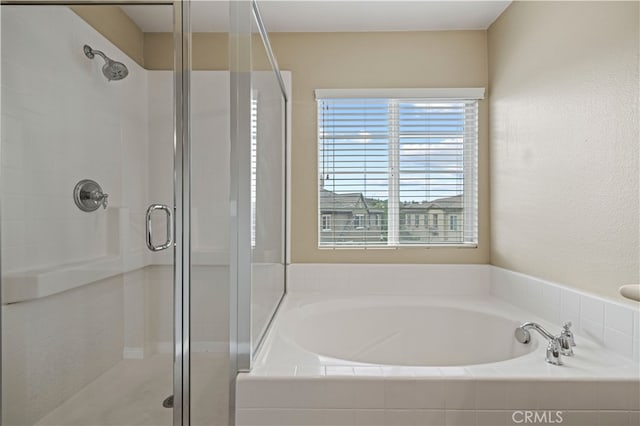 bathroom featuring separate shower and tub