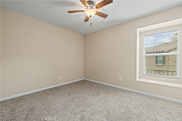 empty room with ceiling fan and carpet floors