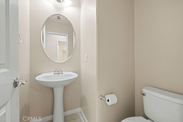 bathroom featuring sink, tile patterned flooring, and toilet