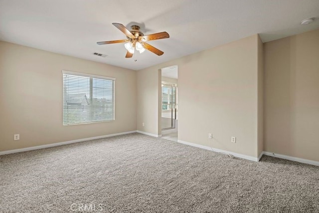 spare room with light colored carpet and ceiling fan