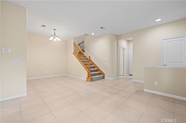 unfurnished room with an inviting chandelier