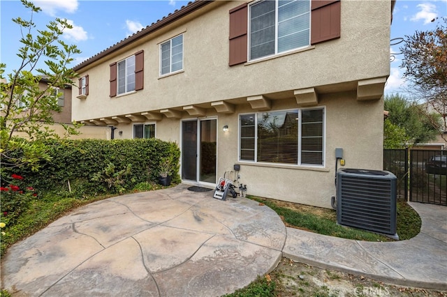 rear view of house with a patio area and central air condition unit