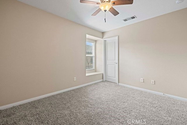 empty room featuring ceiling fan and carpet floors