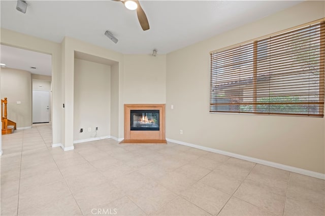 unfurnished living room featuring ceiling fan and light tile patterned floors