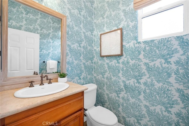 bathroom featuring toilet and vanity