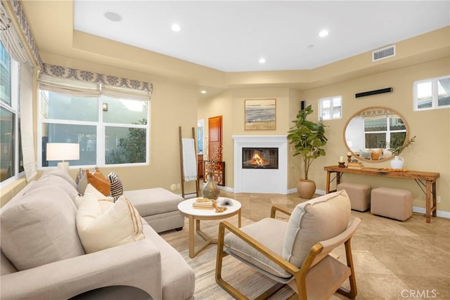 living room featuring light tile patterned flooring and a healthy amount of sunlight