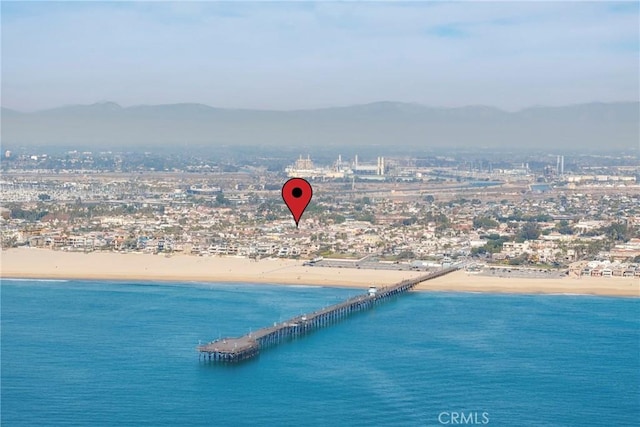 bird's eye view featuring a water and mountain view and a view of the beach