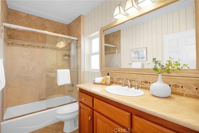 full bathroom featuring backsplash, bath / shower combo with glass door, toilet, and vanity