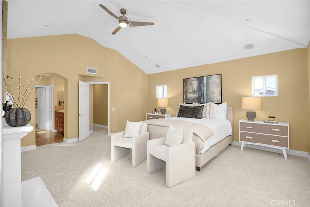 carpeted bedroom featuring ceiling fan, connected bathroom, and vaulted ceiling