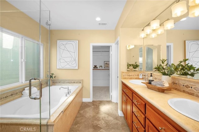 bathroom featuring vanity and independent shower and bath