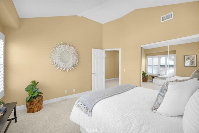 bedroom with light carpet and lofted ceiling