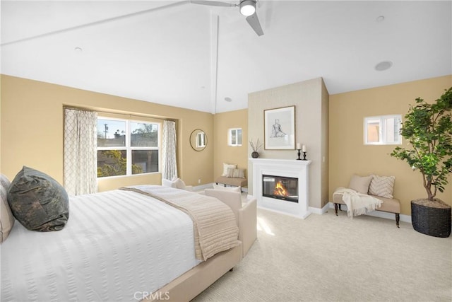 bedroom featuring ceiling fan, light carpet, vaulted ceiling, and multiple windows