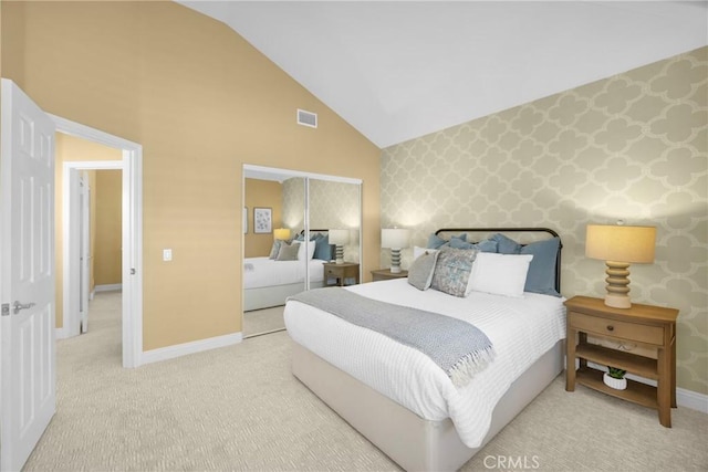 carpeted bedroom featuring high vaulted ceiling and a closet