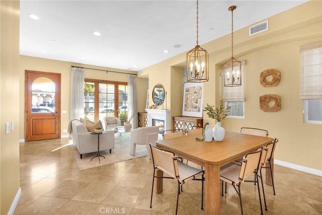 dining room featuring light tile patterned floors and a notable chandelier