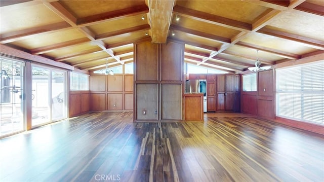 interior space with dark wood finished floors, lofted ceiling with beams, a wealth of natural light, and a chandelier