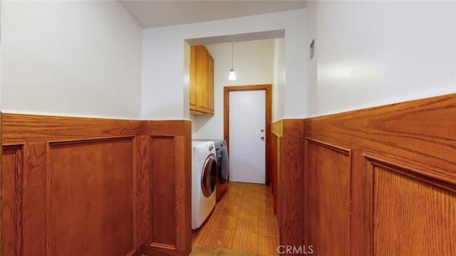 laundry room featuring cabinet space and washer and clothes dryer