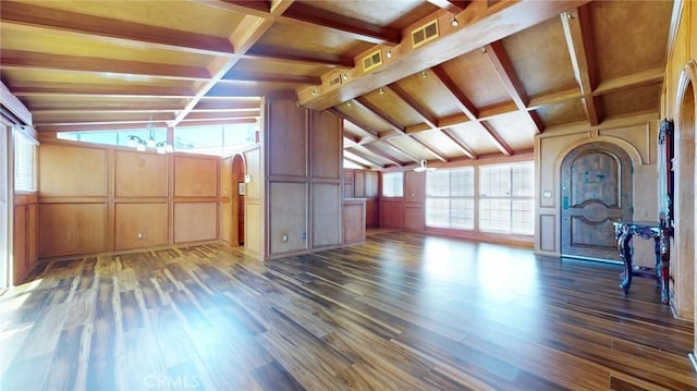 unfurnished living room featuring an inviting chandelier, lofted ceiling with beams, wood finished floors, and coffered ceiling