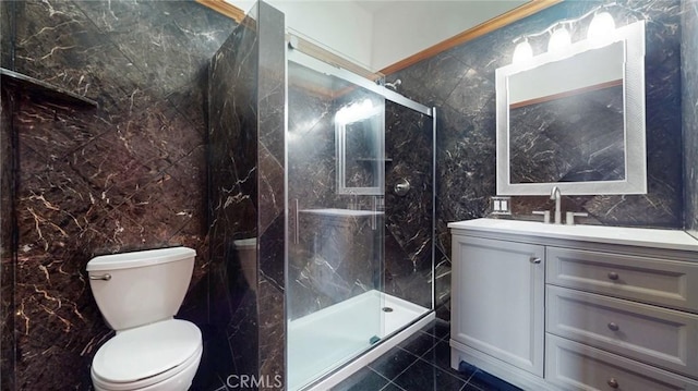 full bathroom featuring vanity, tile walls, toilet, and a marble finish shower