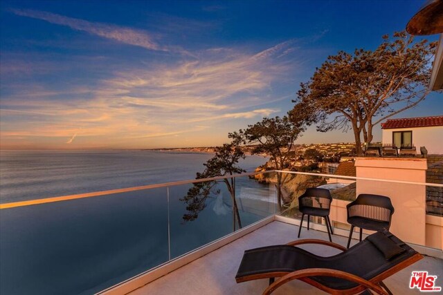 balcony at dusk with a water view