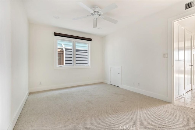 carpeted empty room featuring ceiling fan