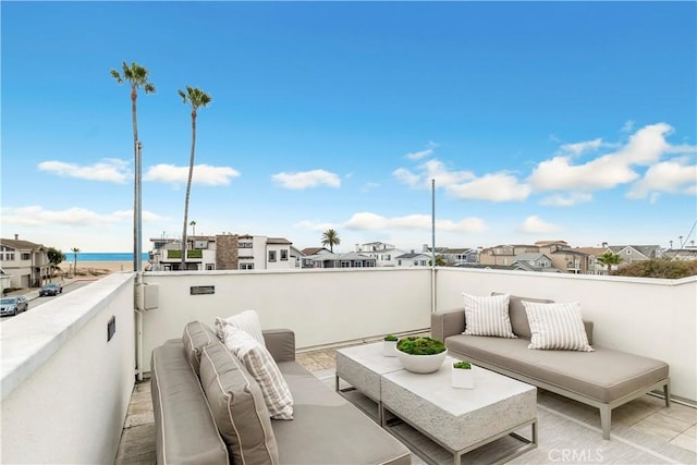 view of patio / terrace with a water view and a balcony