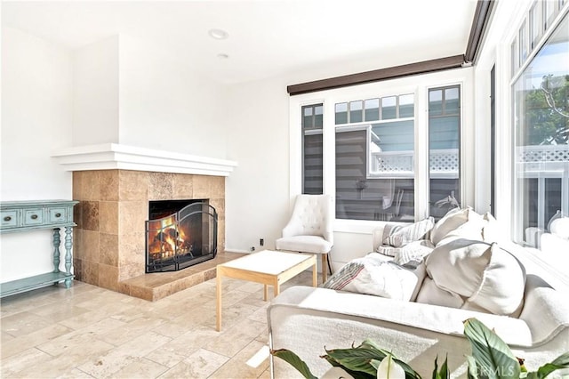 living room featuring a tiled fireplace