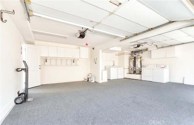 garage with washing machine and dryer, a garage door opener, and gas water heater