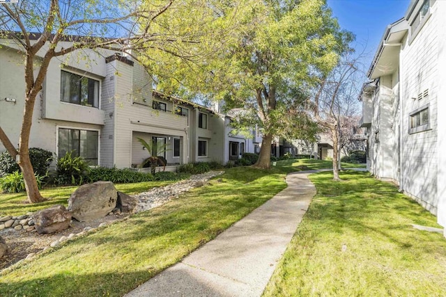 view of home's community featuring a lawn