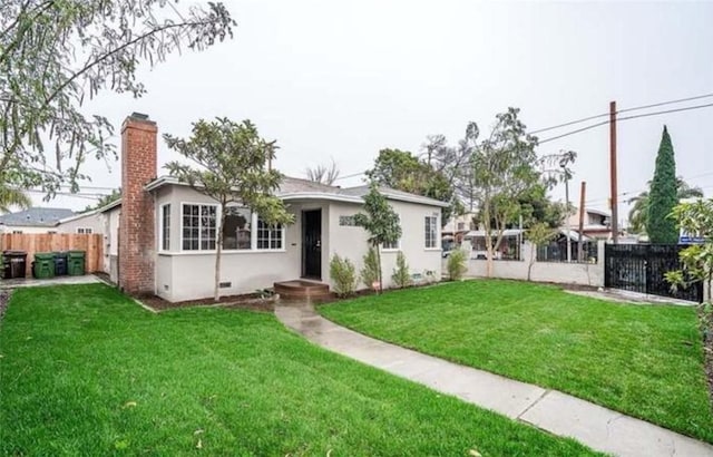 rear view of property featuring a yard