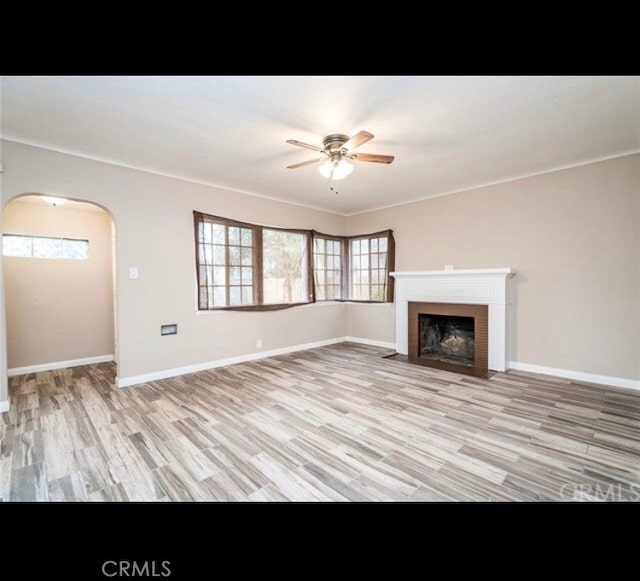 unfurnished living room featuring ceiling fan and light wood-type flooring