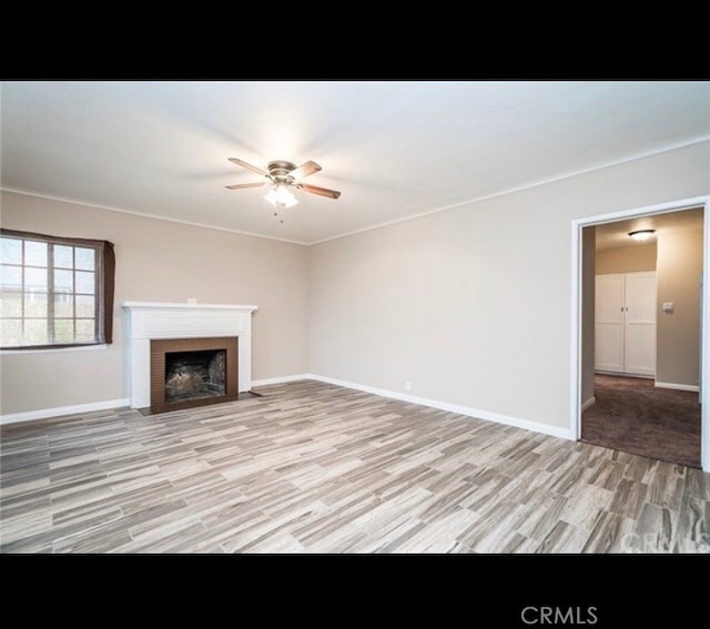 unfurnished living room with light hardwood / wood-style floors and ceiling fan