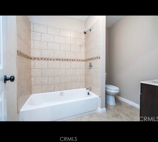 full bathroom with tile patterned floors, toilet, vanity, and tiled shower / bath