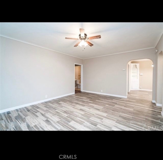 spare room featuring ceiling fan and light hardwood / wood-style flooring