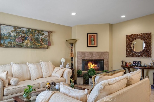 living room with a tile fireplace