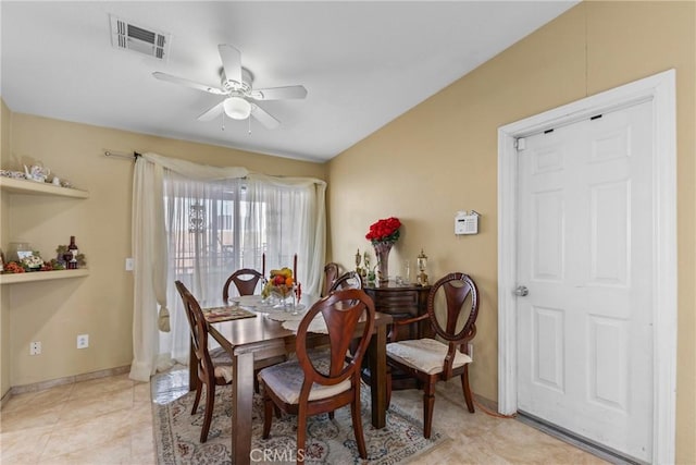 tiled dining room featuring ceiling fan