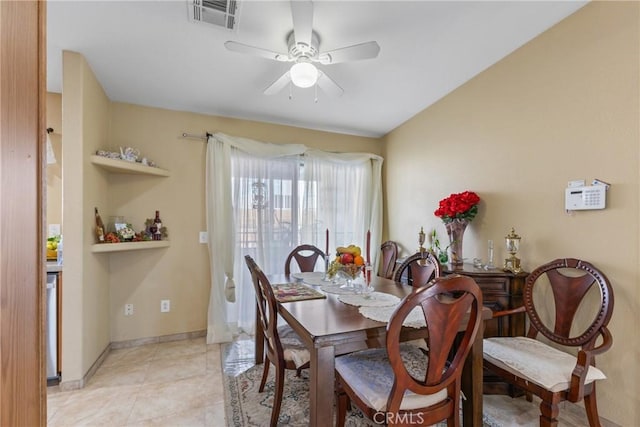 tiled dining area featuring ceiling fan