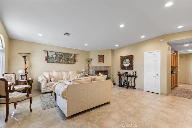 living room featuring a tile fireplace