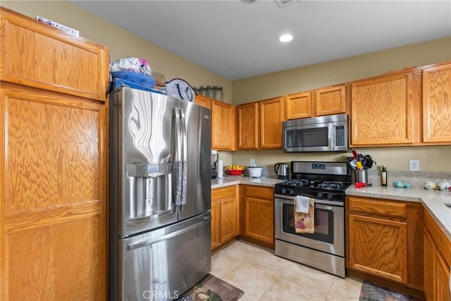 kitchen with stainless steel appliances and light tile patterned flooring