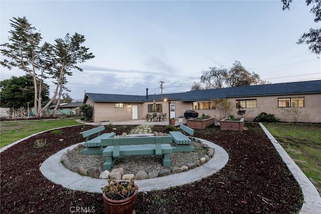 rear view of property with a lawn and a patio area