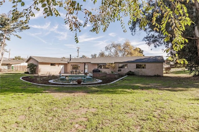 back of house with a lawn